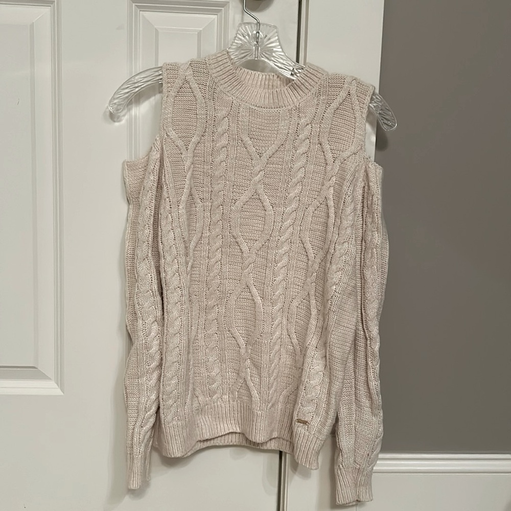 Exposed shoulder knit sweater.